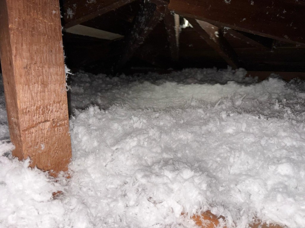 Attic floor with fresh blown-in insulation at depth