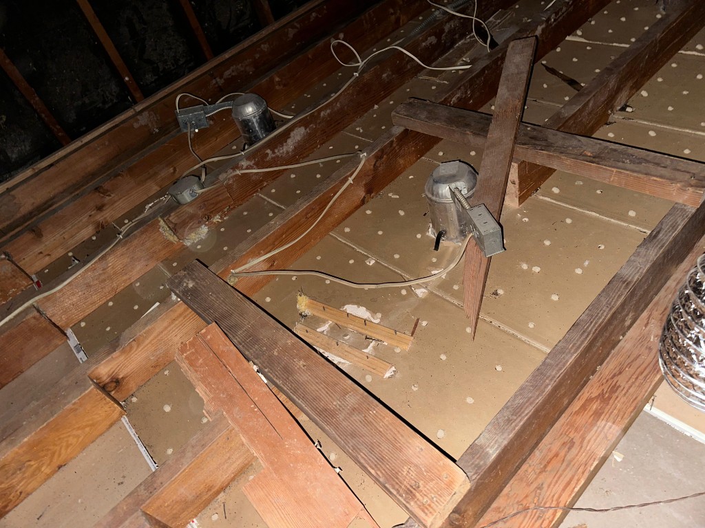 Attic with new fiberglass batt insulation installed to target R-value