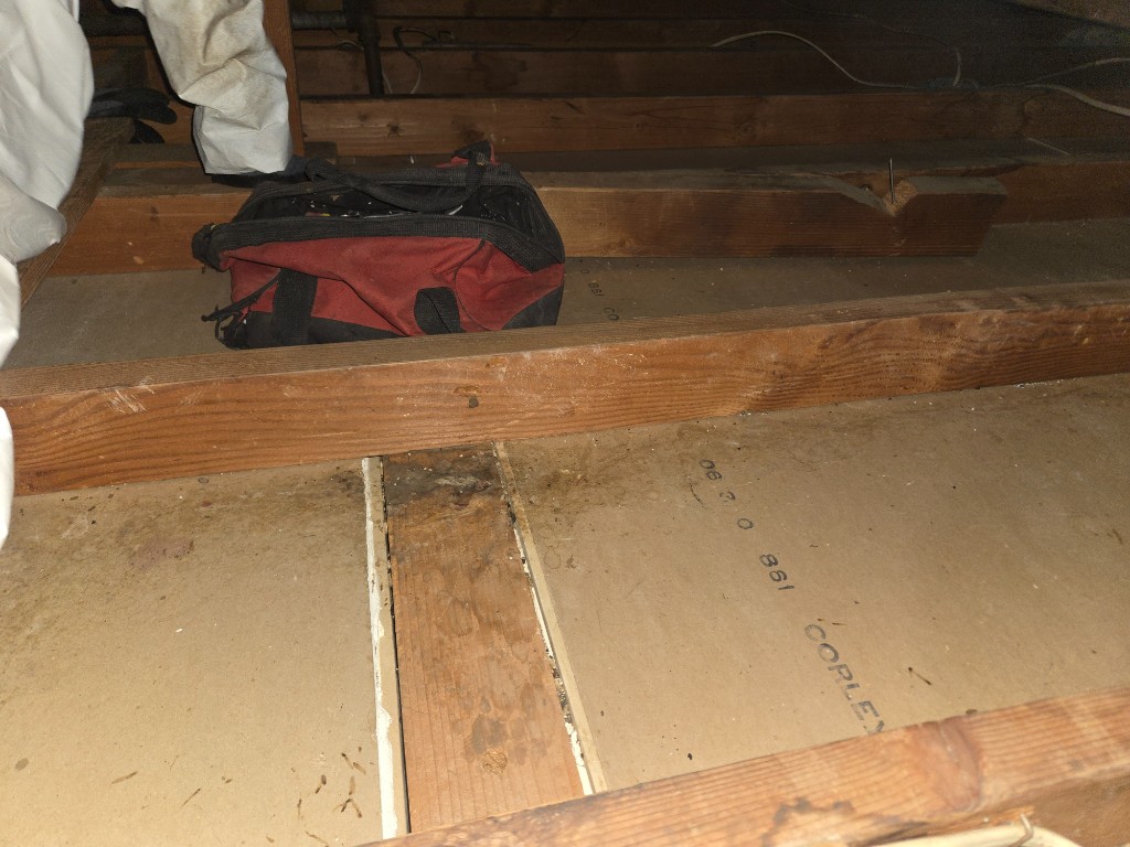 Attic with new fiberglass batt insulation installed to target R-value