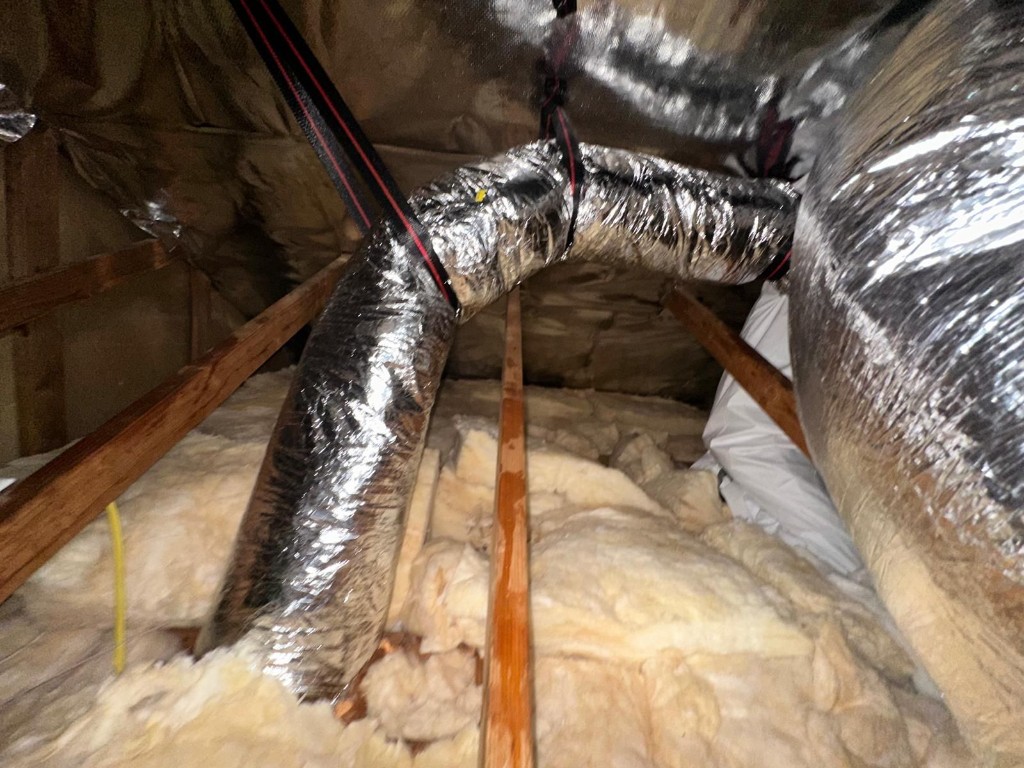 New insulated flex duct runs installed and supported in the attic