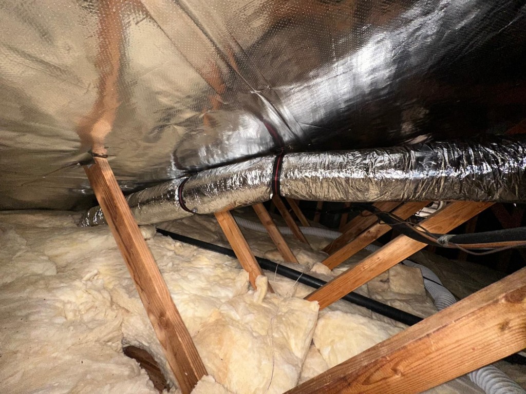 Radiant barrier fully installed across the attic roofline