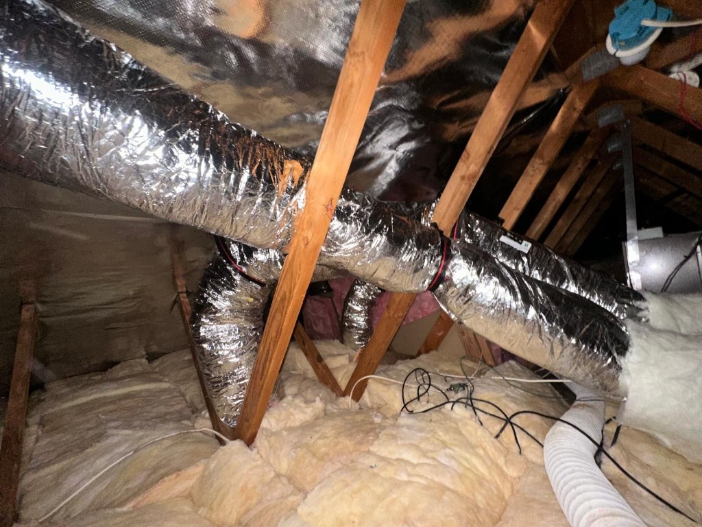 Radiant barrier fully installed across the attic roofline