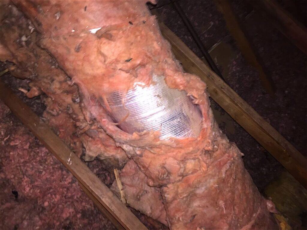 Torn, dirt-caked flexible ductwork before Pure Eco replacement