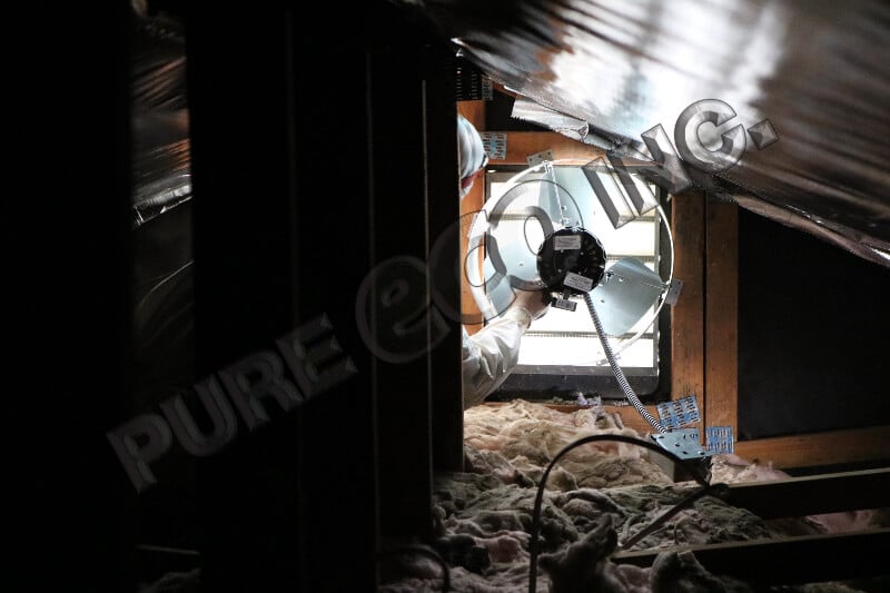 Pure Eco technician installing a powered attic ventilation fan