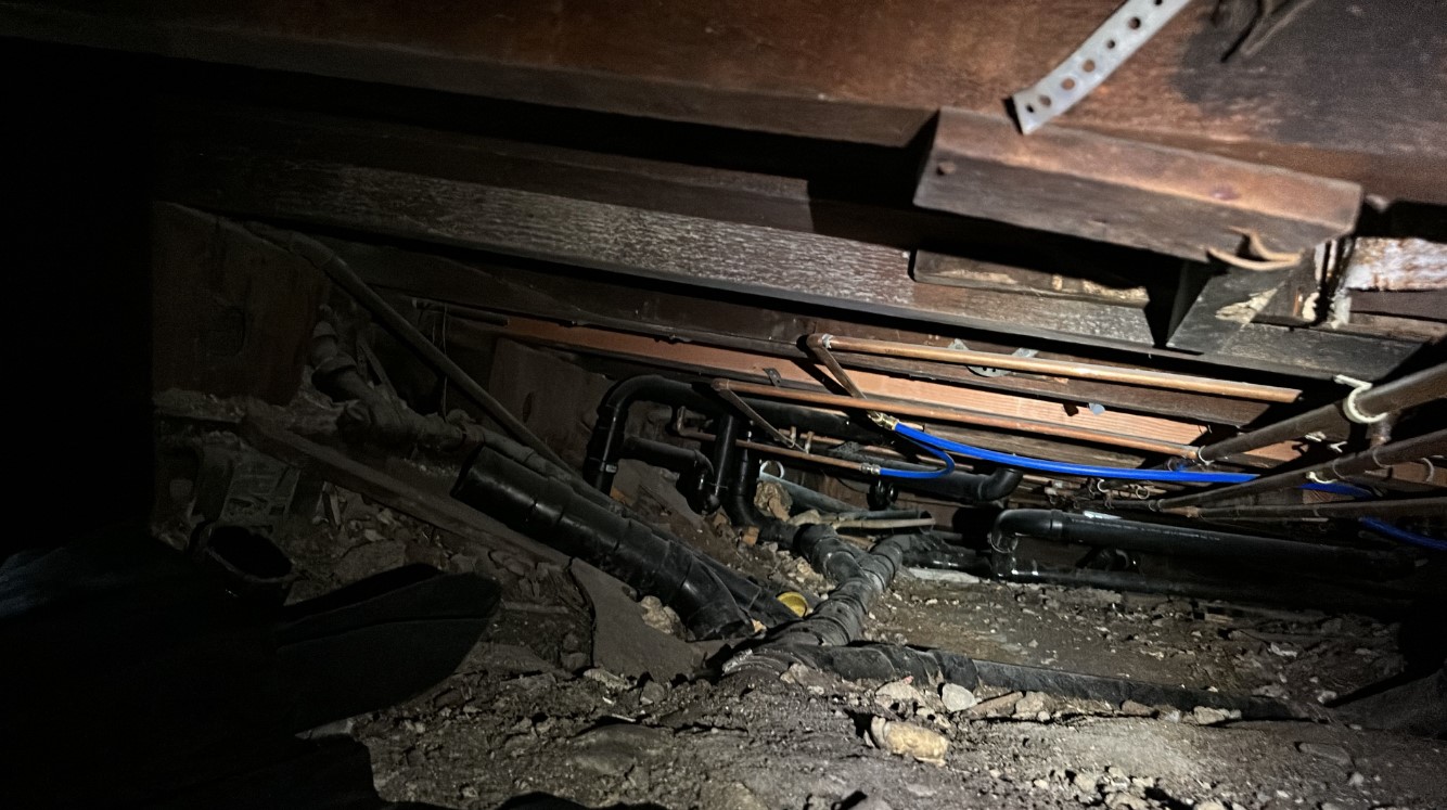 Crawlspace with fallen insulation and debris before Pure Eco cleanout