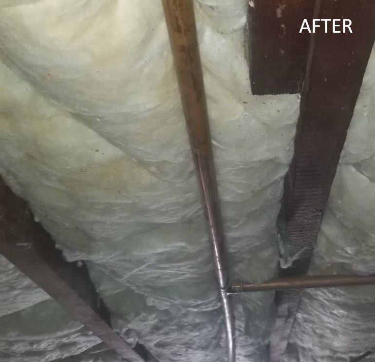 New crawlspace batt insulation secured between floor joists