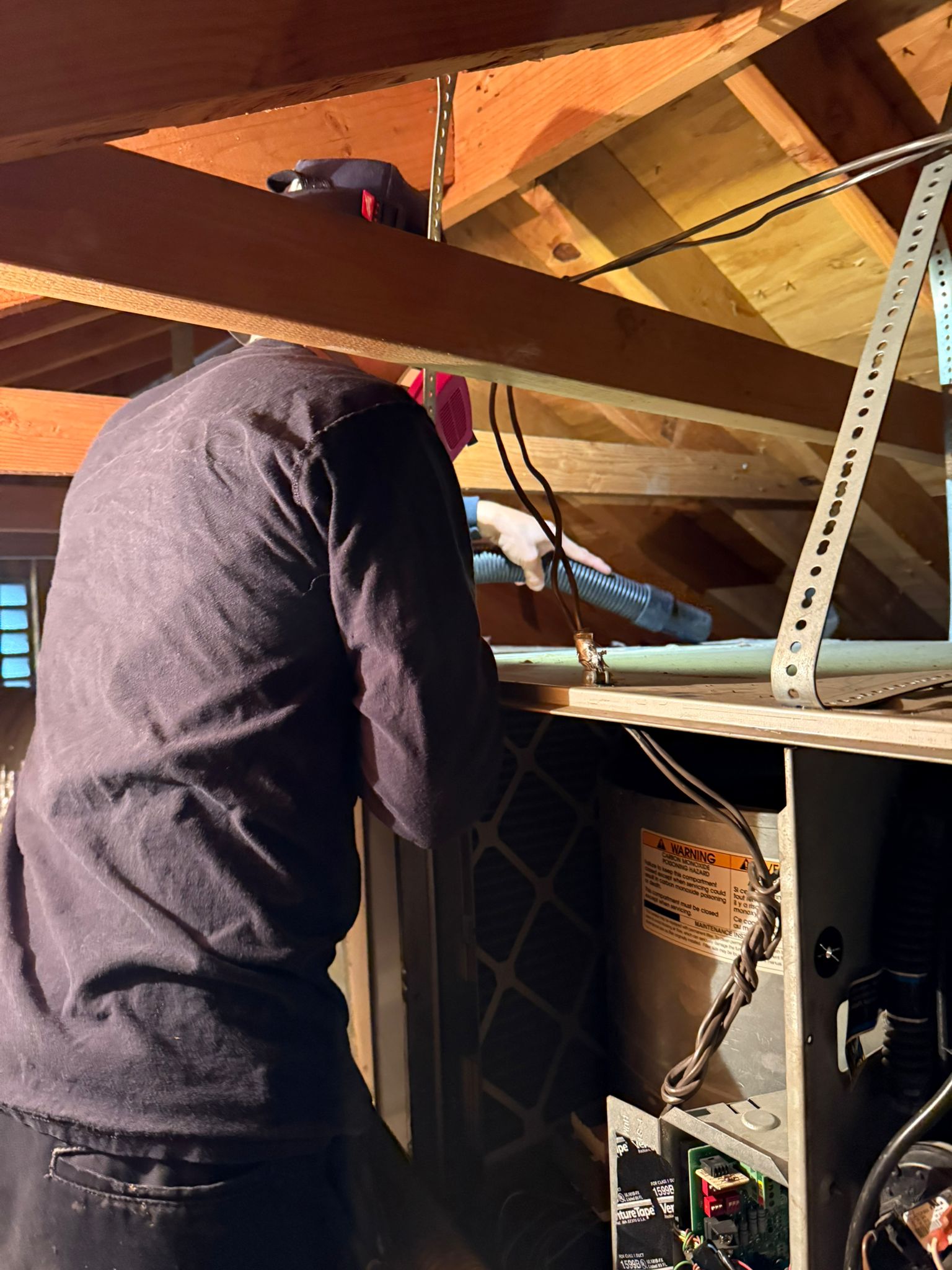 Pure Eco technician servicing HVAC equipment during a system swap