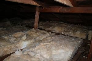 Attic with settled, contaminated batt insulation before Pure Eco replacement