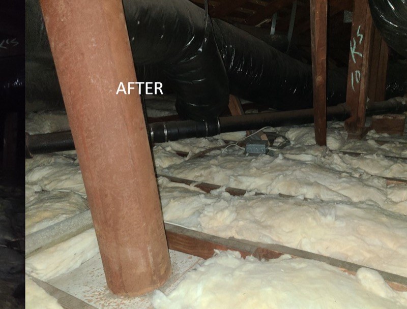 Attic with new fiberglass batt insulation installed to target R-value
