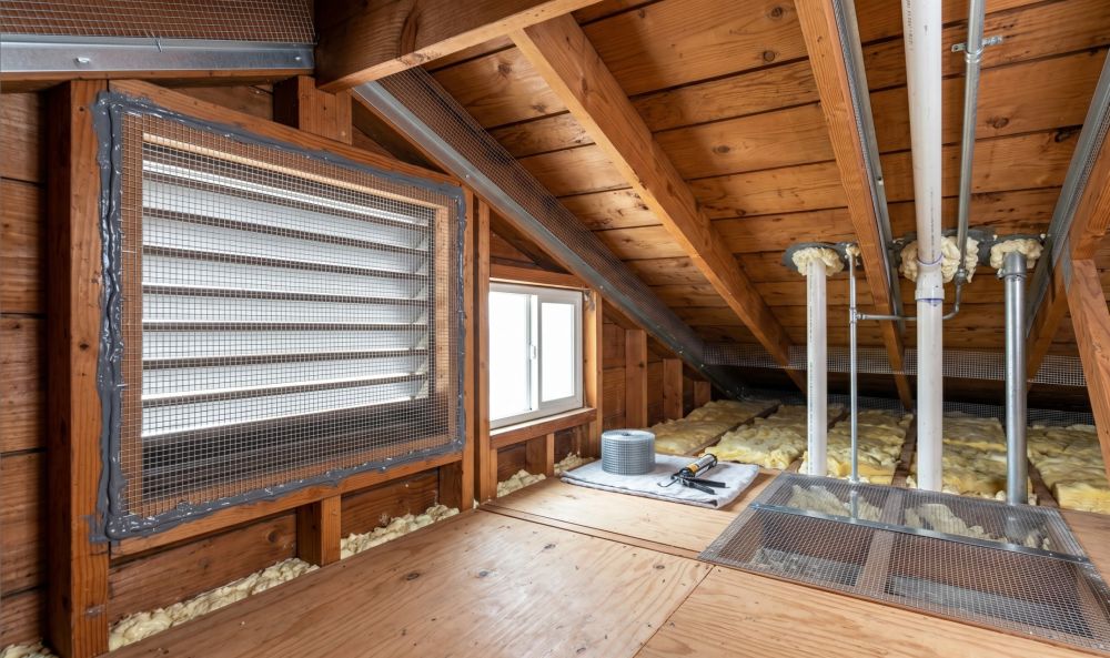 Rat proofing service in Burbank, CA by Pure Eco shows attic entry points sealed with metal mesh and foam to block rodent access. The attic includes exposed beams and insulation with secured gaps around vents and pipes to prevent intrusion. This process helps protect the home from contamination, damage, and air quality issues. Pure Eco provides rat proofing services across Burbank with clean and code-compliant work. Call (877) 870-7998 to schedule an inspection.