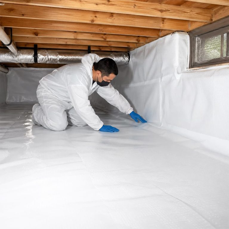 Professional technician installing a white crawl space vapor barrier in Northridge, CA.