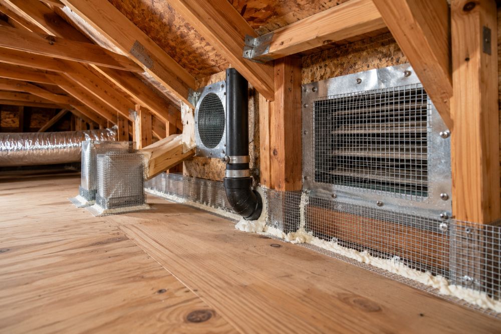Professional Rat Proofing Service in Woodland Hills, CA completed inside a residential attic by Pure Eco. The attic contains exposed wooden framing, HVAC ductwork, attic vents protected with galvanized steel mesh, and sealed entry points designed to block rodent access. Pure Eco serves Woodland Hills and surrounding Los Angeles communities with attic cleaning, insulation, and rodent exclusion services. The workspace appears clean and organized, with visible pest prevention materials installed throughout the attic structure. For attic and rodent control solutions, contact Pure Eco at (877) 870-7998.
