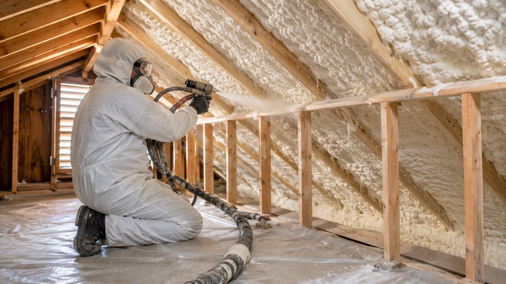A technician applies spray foam insulation inside a residential attic in Sherman Oaks, California. The image shows expanding foam being installed between exposed roof rafters and attic framing to reduce air leakage and improve thermal performance. Pure Eco Inc., based in Los Angeles, provides spray foam insulation services for homeowners who want cleaner indoor air, better temperature control, and lower energy use. The attic appears clean and organized, with fresh insulation creating a continuous air barrier across the roof structure. Pure Eco Inc. serves Sherman Oaks and nearby communities with insulation, air sealing, and energy-efficiency services.